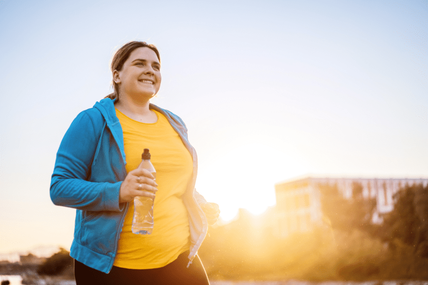 woman holding a water bottle outside